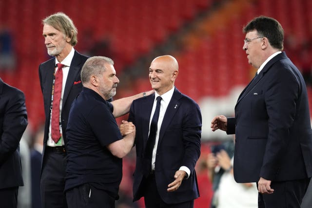 Victorious Tottenham manager Ange Postecoglou, centre left, shakes hands with chairman Daniel Levy after the Europa League final