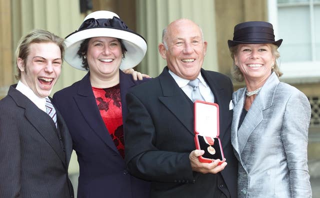 Sir Stirling Moss with his family after receiving his knighthood