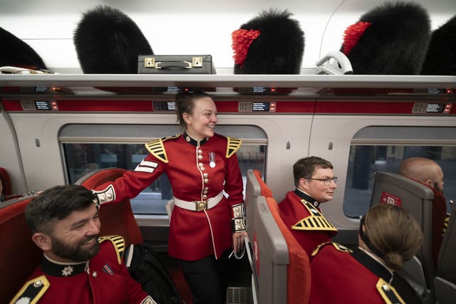 Members of The Coldstream Guards onboard an LNER train at King’s Cross train station in London