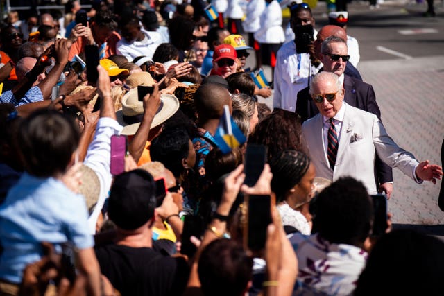 The King meets members of the public during a visit to Parliament Square, Nassau