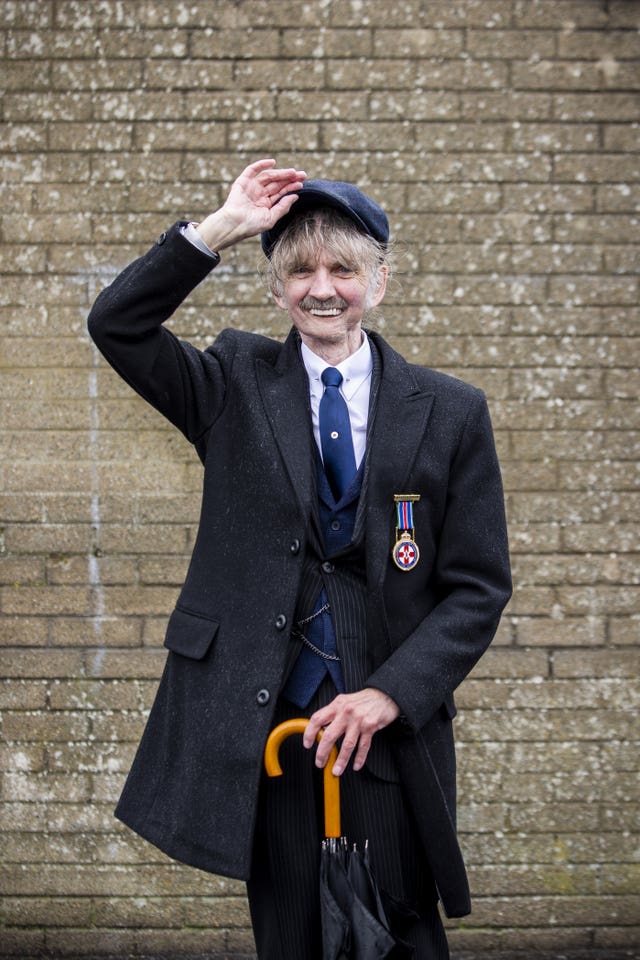Davy Duff of Sir Robert Bateson Memorial Society doffs his hat after a parade along the Longstone Road area of Lisburn to celebrate 100 years of Northern Ireland