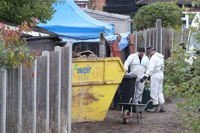 Police beside rubbish tip