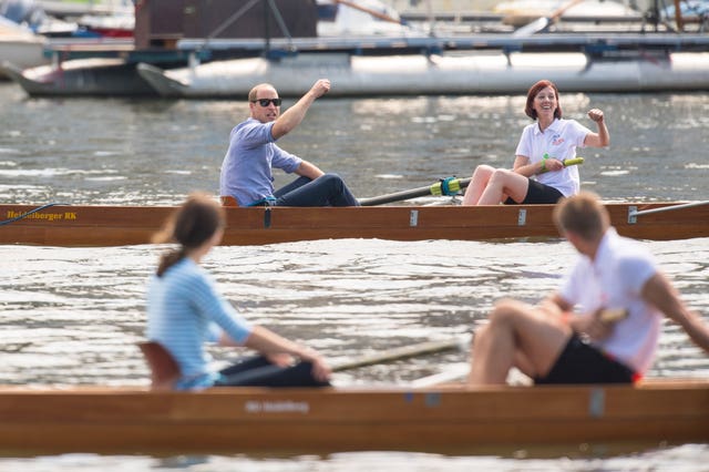 The Duke of Cambridge punches the air as the Duchess of Cambridge looks on after they took part in a rowing race in Heidelberg, Germany, in 2017