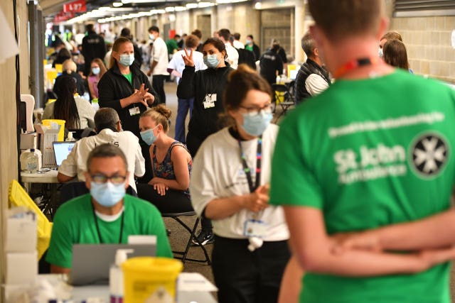 People queue to receive a coronavirus vaccination at Twickenham