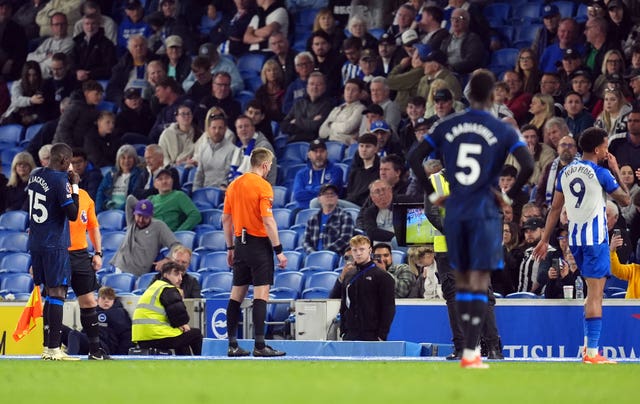 Referee Michael Salisbury checks the pitch side VAR monitor