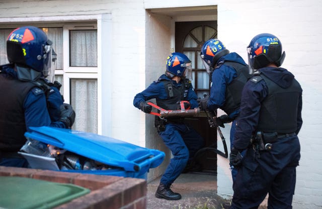 Police officers carrying out a raid