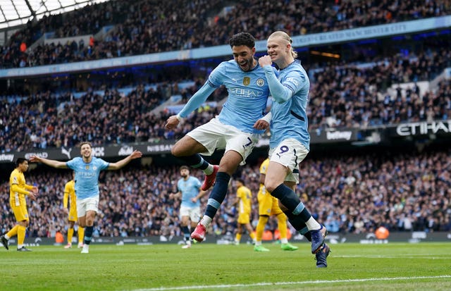 Manchester City’s Erling Haaland (right) celebrates against Brighton with team-mate Omar Marmoush