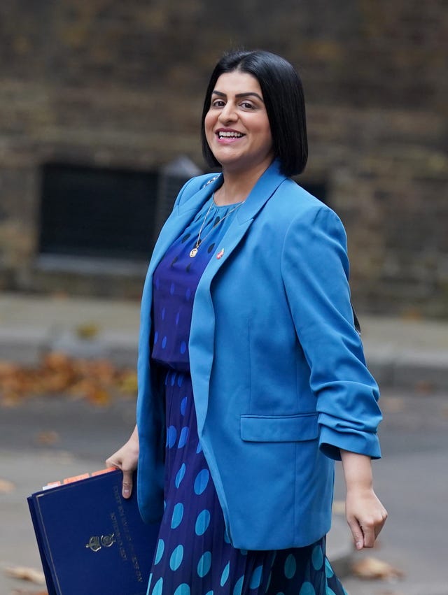 A woman with dark hair and a pale blue jacket