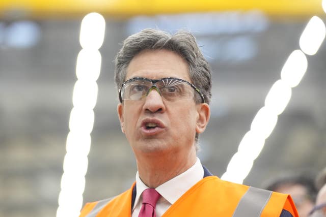 Ed Miliband wearing protective goggles and an orange hi-vis vest