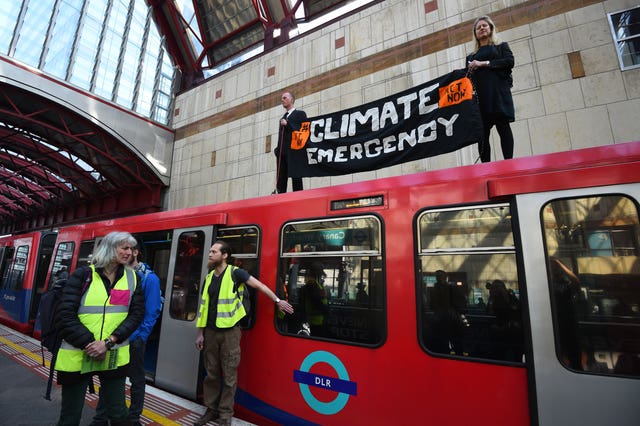 Climate activists protest on a Docklands Light Railway train in London 
