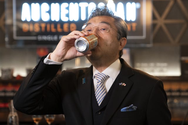 Japanese Ambassador to the UK Hiroshi Suzuki drinking from a can
