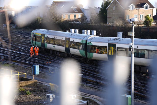 Engineers work on a derailed train at Selhurst train depot 