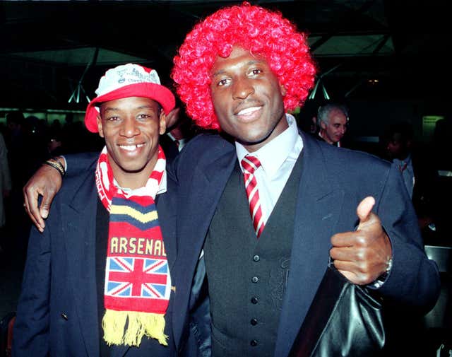 Ian Wright (left) and Kevin Campbell celebrate as Arsenal arrive back at Stansted Airport after their 1-0 European Cup Winners' Cup Final win over Parma