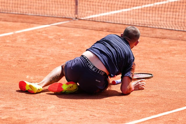 Dan Evans falls during his first-round win 