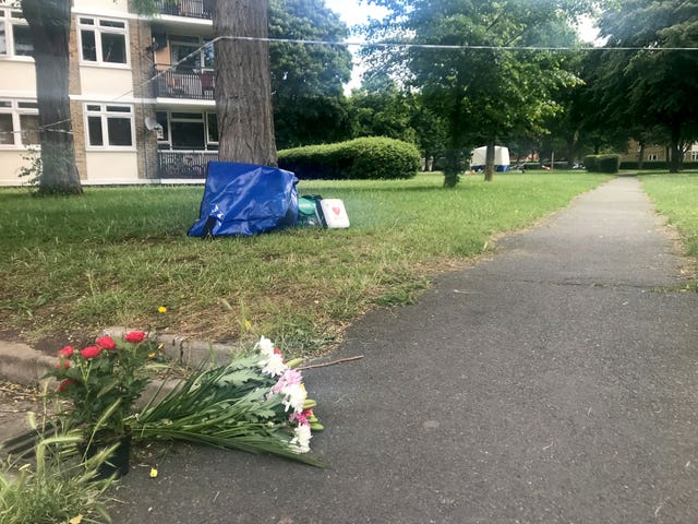 Flowers and medical equiopmet left near to the scene in Deeside Road (Emma Bowden/PA)