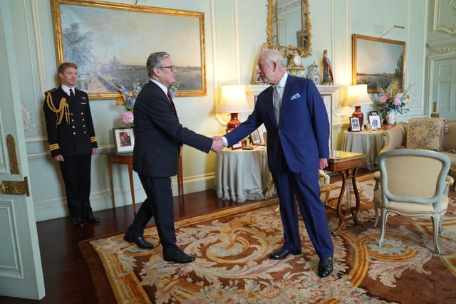 Sir Keir Starmer shaking hands with the King