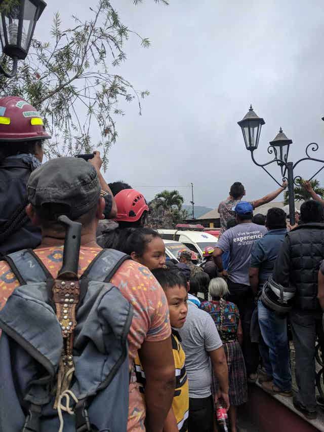 People watching as ambulances carrying bodies arrive in Alotenango on Monday (Matt Goldsmith/PA)