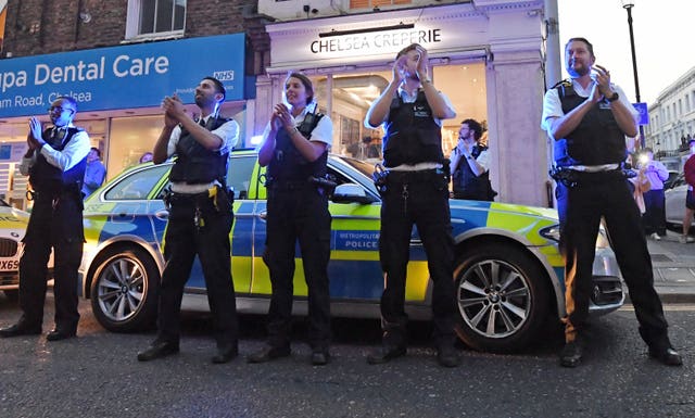 Clapping police officers outside the Chelsea and Westminster Hospital 