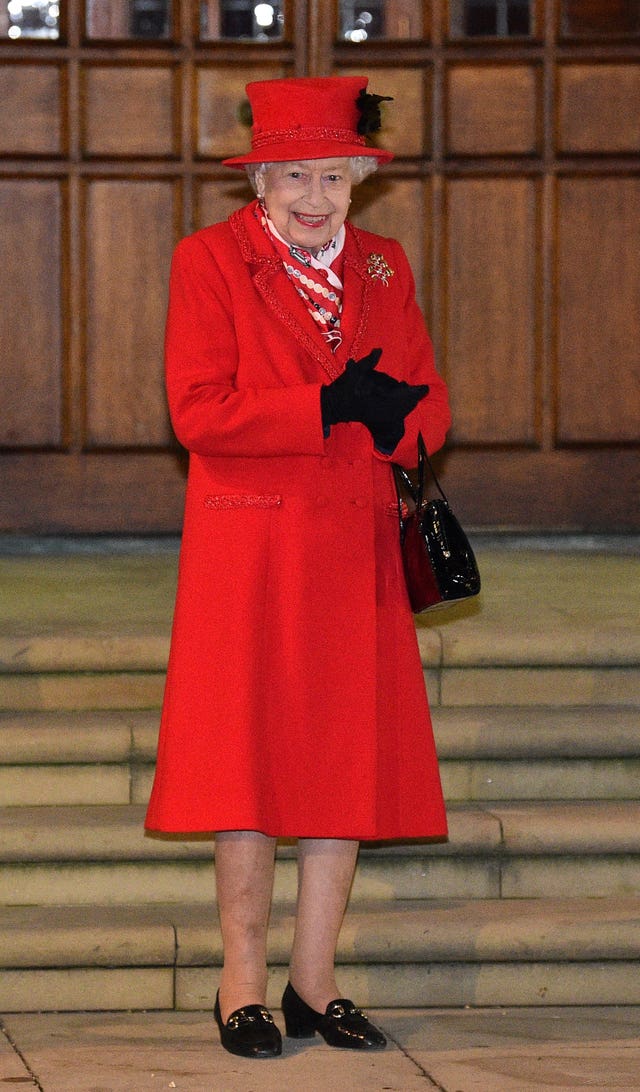 The Queen stands in the quadrangle at Windsor Castle to meet and thank members of the Salvation Army and local volunteers and key workers from organisations and charities in Berkshire, for the work they are doing to help others during the pandemic and over Christmas