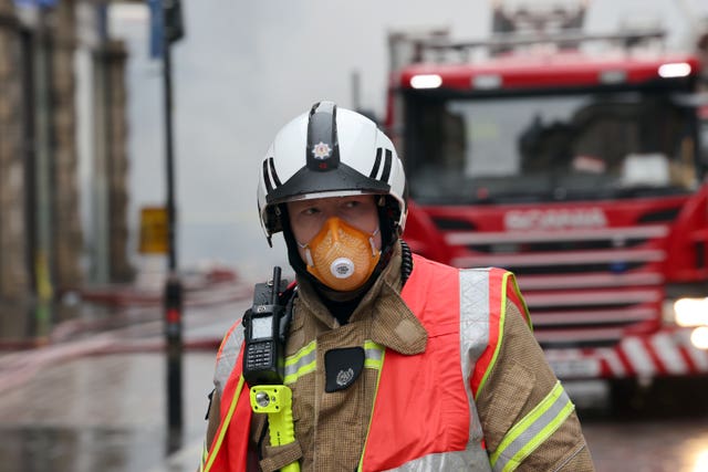 A firefighter in protective clothing at the scene