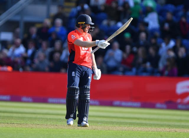 Eoin Morgan celebrates his 50