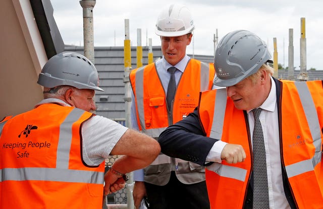 Prime Minister Boris Johnson greets a worker with an elbow bump during a visit to a construction site in Cheshire (Phil Noble/PA)