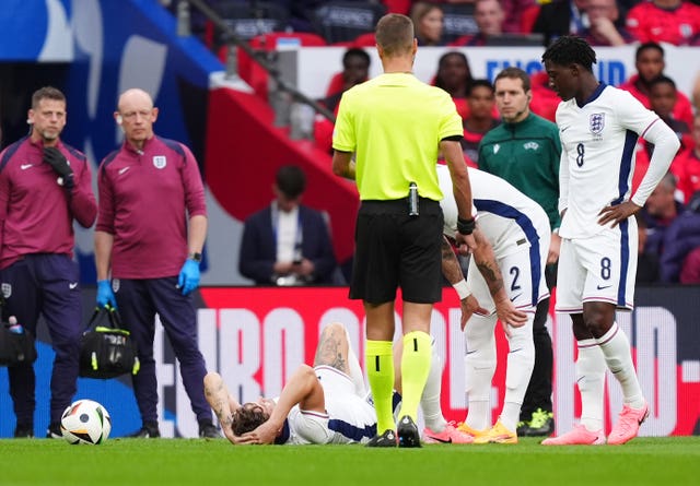 England players surround John Stones after he picked up an ankle injury against Iceland