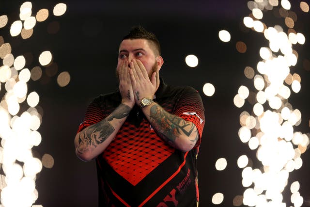 Michael Smith celebrates after winning his semi-final against Nathan Aspinall (Steven Paston/PA).
