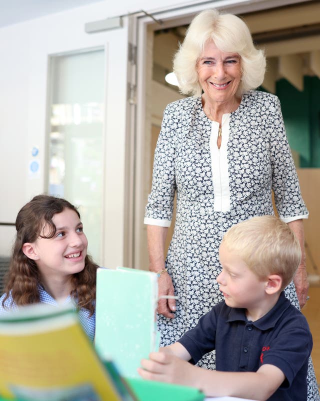 Camilla smiles as she meets young pupils