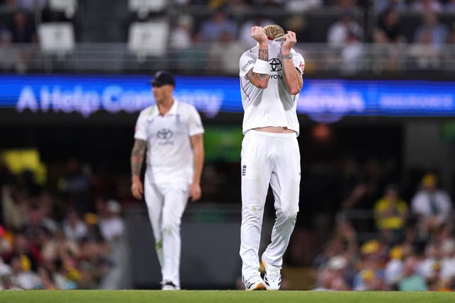 England’s Ben Stokes pulls his shirt over his face in frustration as Australia bat in Brisbane