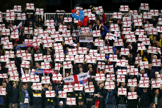 Kosovo fans hold England flags in the stands during their Euro 2020 qualifier