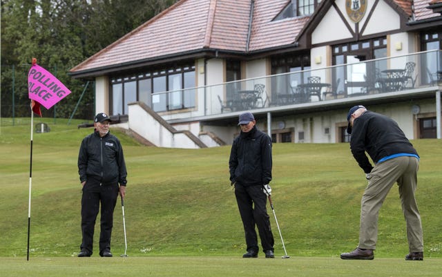 Golfers Colin Tait, Richard Wilson and Stewart Crawford practise putting as they arrive to cast their votes in the Scottish Parliamentary election at the polling station in the club house at the Merchants of Edinburgh Golf Club