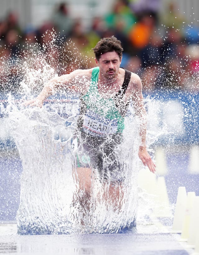 Declan Neary splashes his way through the water jump in the mens 3,000m steeplechase at the UK Athletics Championships and Olympic trials in Manchester