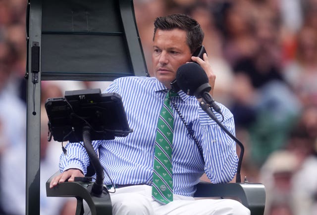 Umpire Nico Helwerth on the phone after the line-calling technology failed on Centre Court 