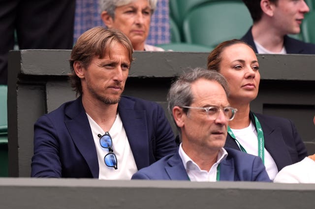 Luke Modric, left, sits in Carlos Alcaraz's box