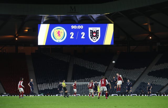 The scoreboard shows Scotland's 2-2 draw with Austria