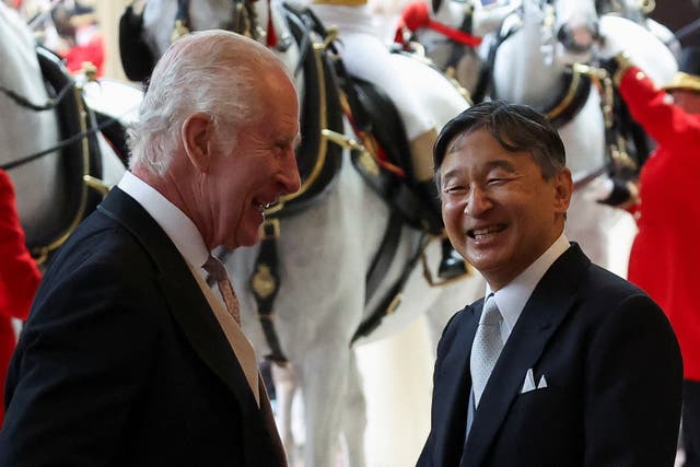 The King and Emperor Naruhito are seen smiling as they arrive at Buckingham Palace