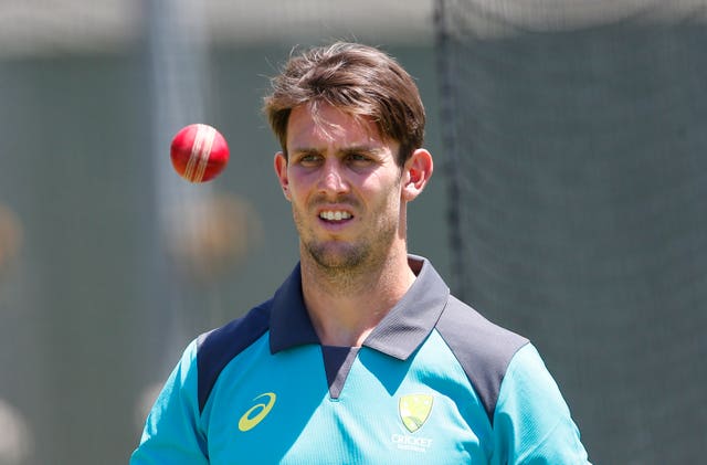 Australia captain Mitch Marsh tosses a cricket ball at net practice.