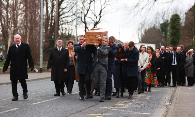 Patrick Kielty, right, carries his mother's coffin to the Church of the Sacred Heart in Dundrum for her funeral