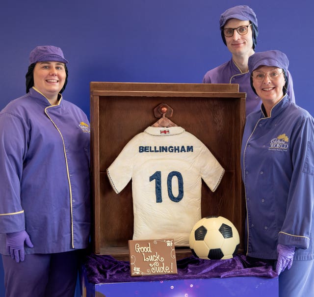 Three chocolatiers stand next to a Jude Bellingham chocolate England football shirt and ball