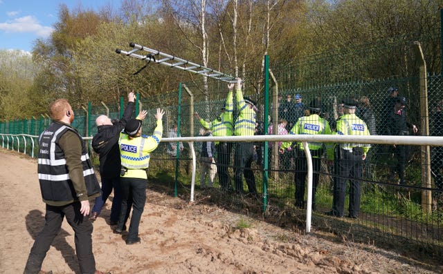 Ladders are removed from protesters by police at Aintree
