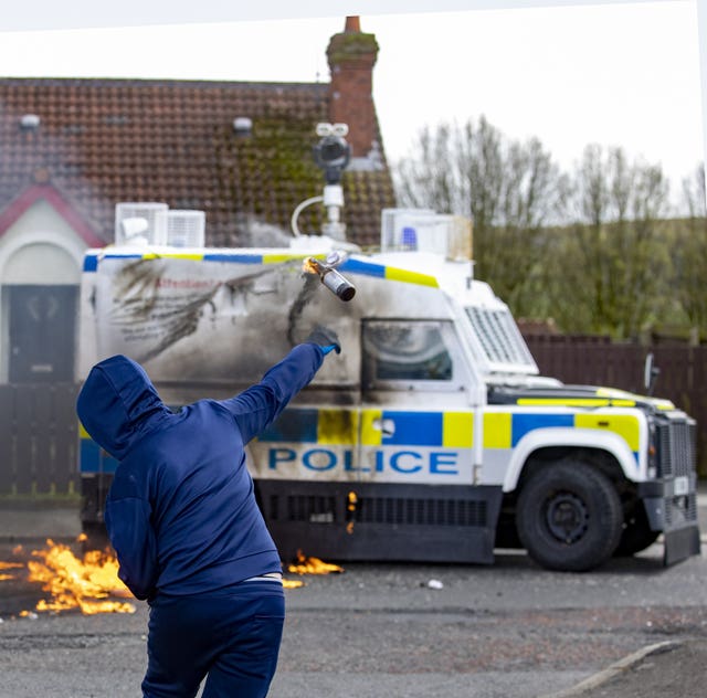 Youths throw petrol bombs at a PSNI vehicle ahead of a dissident Republican parade in the Creggan area of Londonderry on Easter Monday