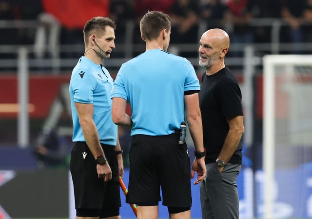 Stefano Pioli, right, speaks to the referee after AC Milan's defeat to Chelsea