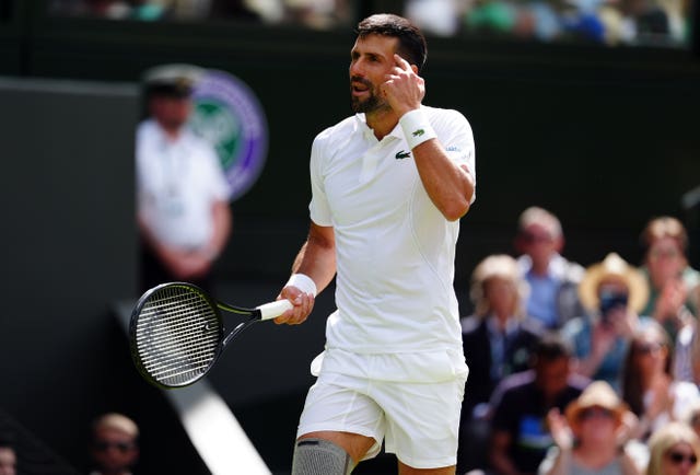 Novak Djokovic points to his head