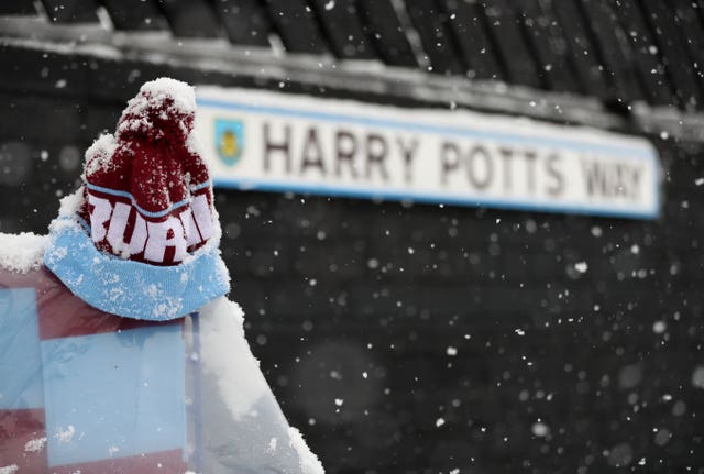 Snow falls on Harry Potts Way outside Turf Moor