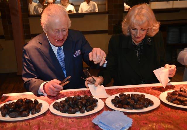 Charles and Camilla help pack donation bags at the restaurant 