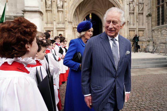 The King meeting young choristers outside the entrance to Westminster Abbey after the annual Commonwealth Day Service 2023