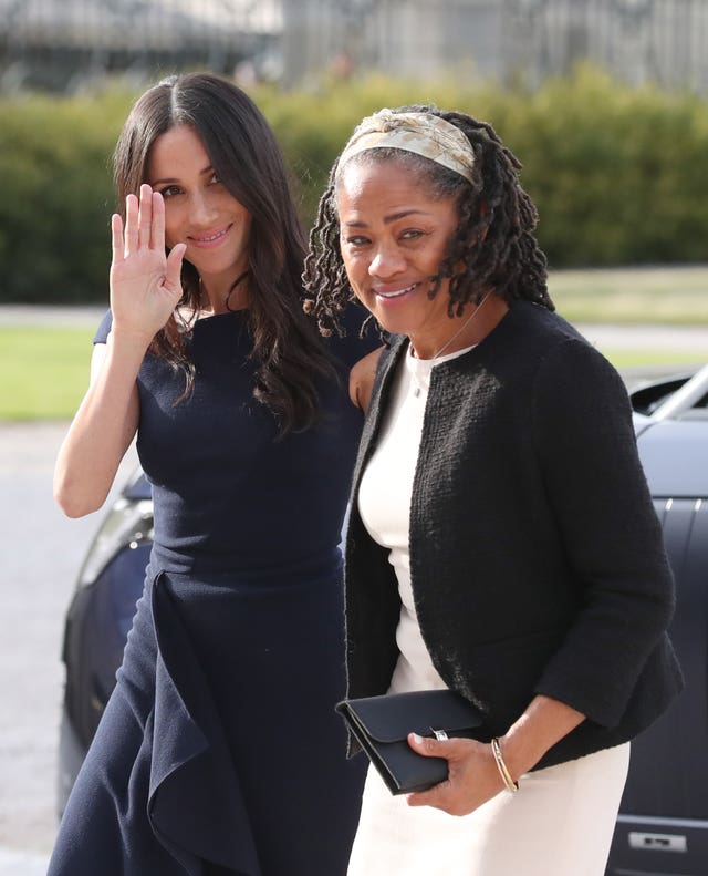 Royal wave: Meghan waves as she arrives with her mother at Cliveden House (Steve Parsons/PA)