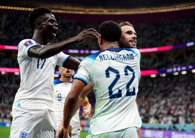 Jude Bellingham, centre, takes the plaudits as England celebrate Jordan Henderson's goal against Senegal
