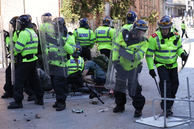 An injured man is attended to during a protest in Liverpool